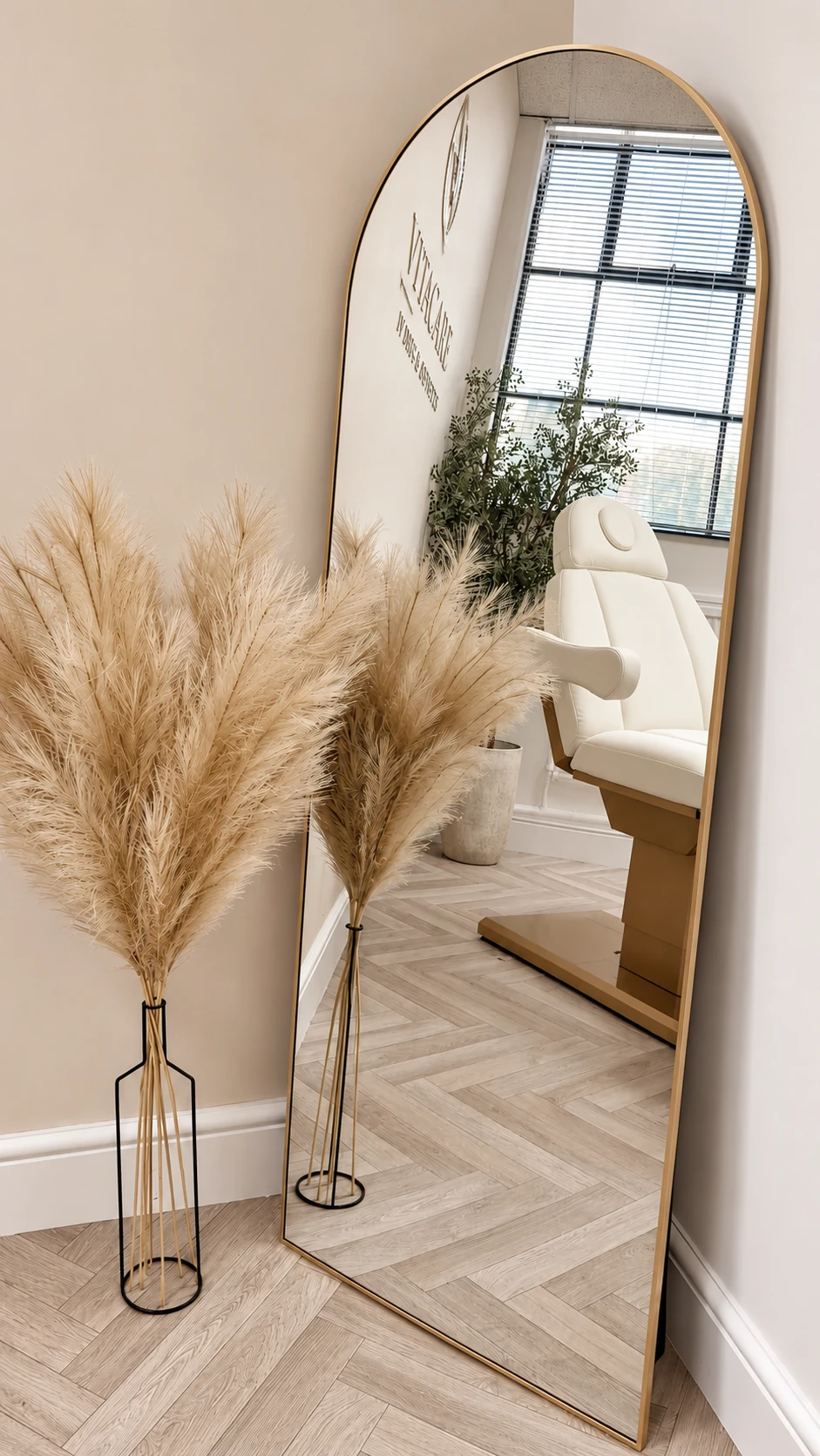 Gold-framed mirror and floral details inside VitaCare Clinic